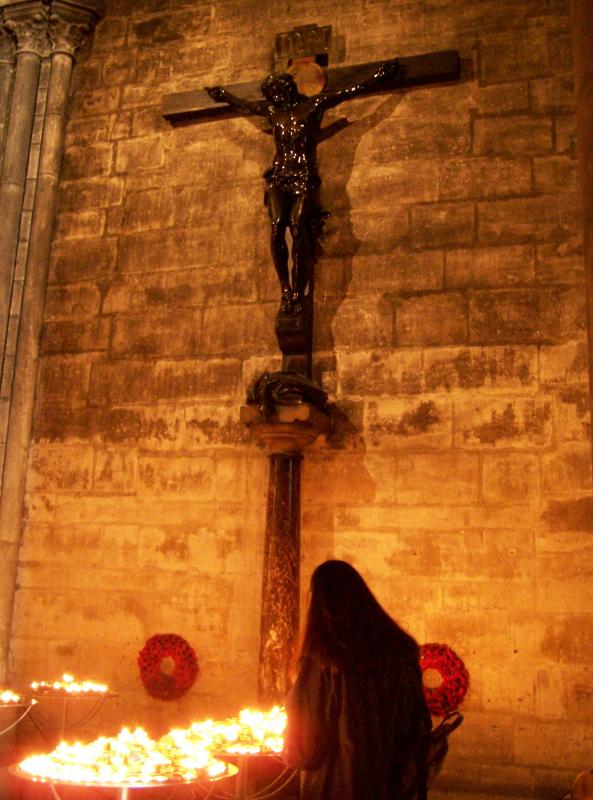 A Woman Praying Inside Notre Dame Cathedral