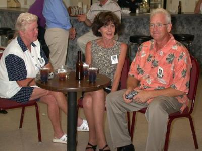 Beverly C., Lois S., and Denny B. chatting.