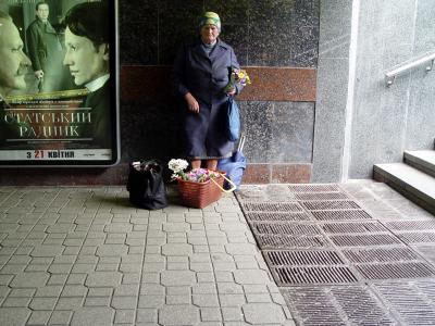 Woman Selling Flowers at the Subway Entrance*  by Colin Guard