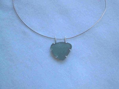 Prong set beach glass chunk.  Approx 2x3 cm. not for sale