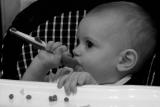 Olivia using spoon for the first time.