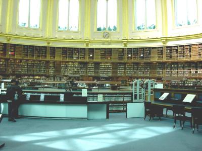 British Museum's enormous reading room. Beyond windows at the top are restaurant tables.