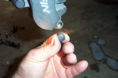 Now I remove the plug over the brake pad pin bolt