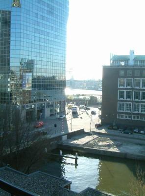 Looking at the SE from my balcony. to the left is the Rijkswaterstaat building, named 'de Maas'. It has a glass facade, which gives it a different aspect/reflection 
on every different moment of the day. To the right is the former bank building of the 'Nederlandse bank' which is on the municipal monument list. It was built in the 
50s of the last century. A new appartment building is to be built on top of it in the coming years.