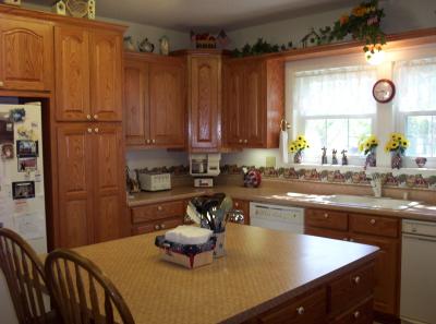 This view of the kitchen was taken from standing in the breezeway doorway. It shows my favorite cabinet of the whole room - the upper corner one.