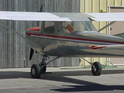 silver airplane at Falcon field