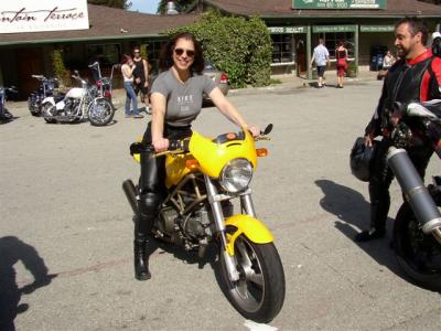 Kate sizes up a Ducatti Monster as the bike's owner looks on
