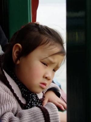 A little girl sitting beside me in the ferry.