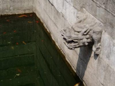 Dragon head feeding water into the pond.