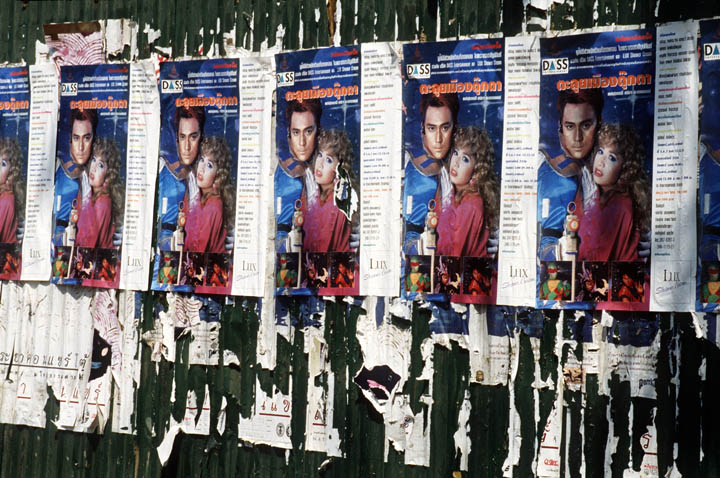 Movie posters cover fence.