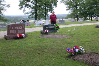 Mary standing behind my Dad's gravestone. My uncle Mack's grave is in the right foreground. My Grandpa and Grandma Brown's grave is on the left.