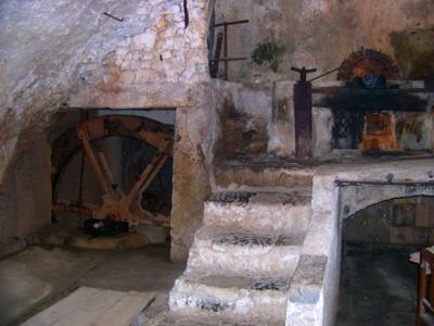 By 17 c., had metal machines: Cotton rags pulverized in tub (above steps) by metal wheel powered by water wheel.