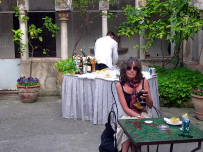 Judy having a glass of wine in the 13th century hotel cloister.
