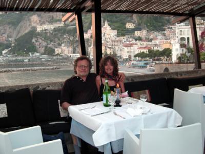 Judy and Richard having dinner at the restaurant in the guard tower. Amalfi is in the background.