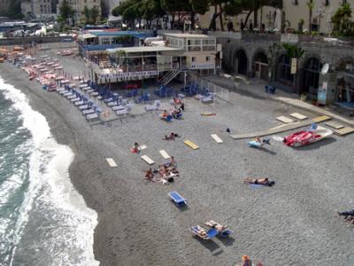 The beach in Amalfi.  Small stones cover the beach. Beach chairs are a requirement for the uninitiated.