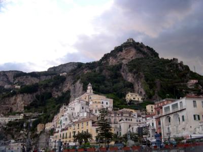 Amalfi and a structure on the mountaintop, as seen from the beach. People somehow built that structure on the mountaintop.