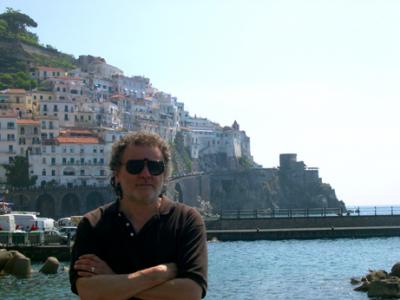 Richard waiting on a pier in Amalfi for the boat to the Emerald Grotto. Our hotel is seen at the top of hill in the background.