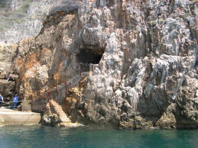 Entrance to Emerald Grotto: Discovered by fishermen in 1932. They entered via the steps. Public entrance via dock on the left.