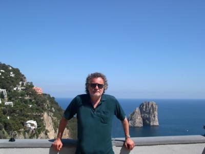 Richard on the terrace of Augustus' Gardens, with the south shore & Faraglioni Rocks in background.
