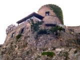 Tower and restaurant  near hotel as seen from pool area. Tower at least 500 years old.  Protected against pirates & invaders.