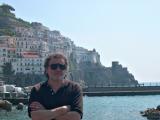 Richard on a pier in Amalfi. Our hotel and guard tower are seen at the top of the hill.
