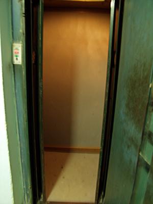 The elevator w/doors open. Outside and inside doors all manually operated.