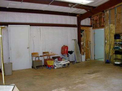 view from inside garage toward house entry (right) and man door exit to back yard (left)