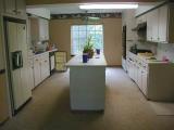WOW - what a NICE kitchen!!! (breakfast nook with ceiling fan at end)