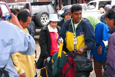 Weighing in extra luggage for porters to carry