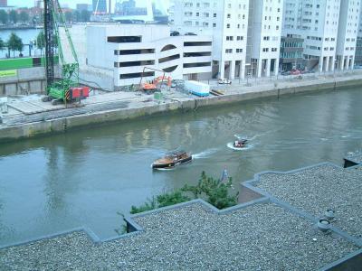 A water taxi passed by that moment, towing a little boat.