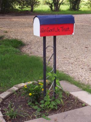 That same mailbox's current look.  I transplanted some wild Morning Glories from out of my vegetable garden to the base of the mailbox.  I'm hoping they will soon cover the upright portion.  Also, my yellow Margarite (daisy) bushes are starting to make a comeback after their initial transplanting shock.