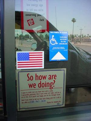 American flag at Jack in the Box and reflection of the green truck club