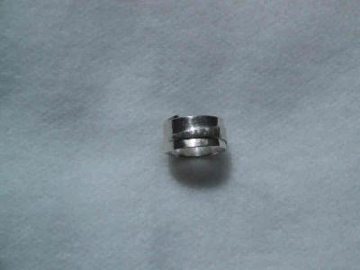 This ring is made with a long, tapered strip of silver, which is wrapped around and textured to highlight the wrap.