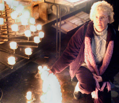 Cheryl lighting a candle for her father, Richard McKelvie - in the new, modern church next to the old, bombed out church in central Berlin.