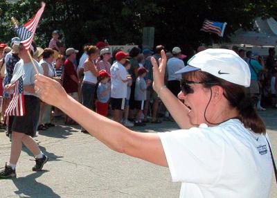Suzanne cheers the marchers and the floats.