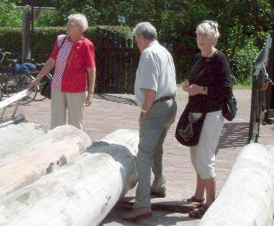 Yfke, Uilke and Martha standing near some logs still to be sawed