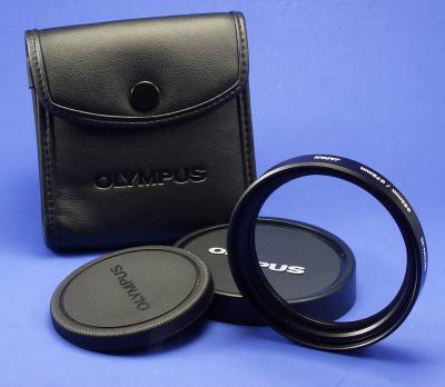 This is the Olympus Macro 35, it is a macro lens. The lens has a 62mm threads on the camera end and 72mm on the filter end. The operating range of the Macro 35 is from 4.7 inches to 13.8 inches and unlike most of the other extension lenses, it can be used over the full range of the zoom. 
The lens come in a small case with a screw on rear cover and a snap on front one. 
This link will give you more info on the Macro 35 
http://davidweikel.com/E10_samples/mcon35/mcon1.shtml

By Bill Huber