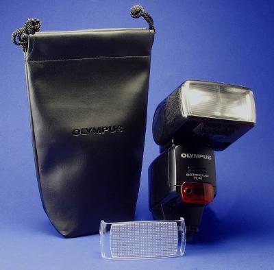 This is the Olympus FL-40 external flash. This is a very very good flash, put it on you hot shoe or the handle and plug it into you camera and away you go. It is a TTL flash and as a very good range. The guide number is 40 for Tele Zoom an 26 for wide zoom. The head will turn almost 360 degrees and will left up to shoot bounce off the ceiling. It uses 4 AA batteries and is very good on batteries. The down side is its cost, very high.  

Michael Meissner excellent flash FAQ
 http://www.the-meissners.org/olympus-flash.html

By Bill Huber
