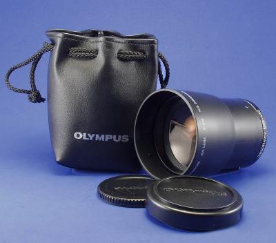 This is the Olympus C-210 1.9x Tele-converter. I has a 49mm camera end threads and no filter end threads. It can use on a lot of Olympus cameras, using an adapter ring. It does have a lot vignetting Even at full zoom.
To see this lens in action here is a link.
http://www.pixelbrat.com/teleconverters.html

By Bill Huber
