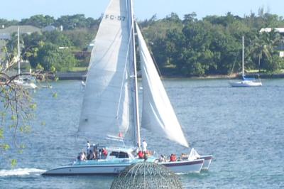 radical zoom of catamaran about a mile away from inside the Cloisters
