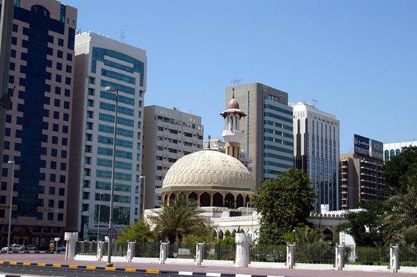 Modern buildings surround the square with the old fort and this mosque