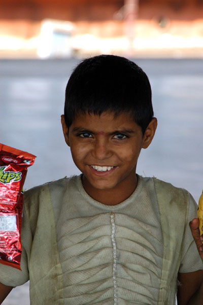 A child beggar at Agra Cantt with a bag of chips