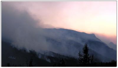 Sun Disappearing Behind Smoke Filled Mountains 2003