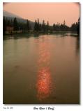 The Bow River with the reflection of the red sun.