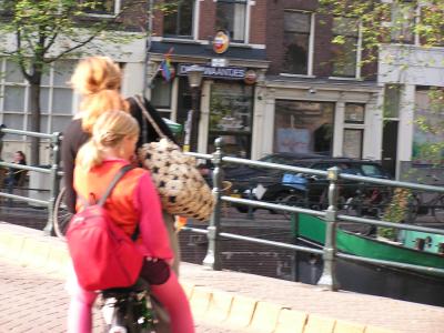 Multiple kids catch bike rides with parents