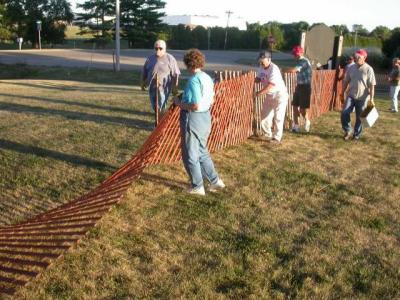 Guys and gals both build fence