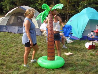 Donna and Janet set up an inflatable palm tree...
