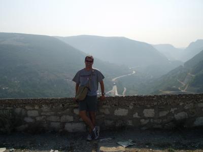 The ugly American, wearing hideous sunglasses, leaning against a wall of an old Turkish fort.
