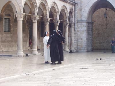 Nuns in black, Nun in white