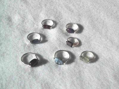 Rings made with semi-precious stone beads set in sterling silver bands. Various sizes.